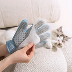 Pet grooming glove being used to remove loose cat fur