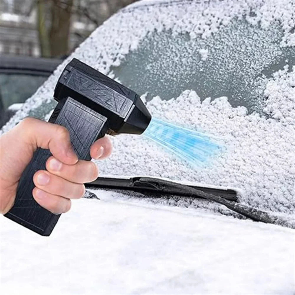 Rechargeable electric air duster clearing light snow from a car